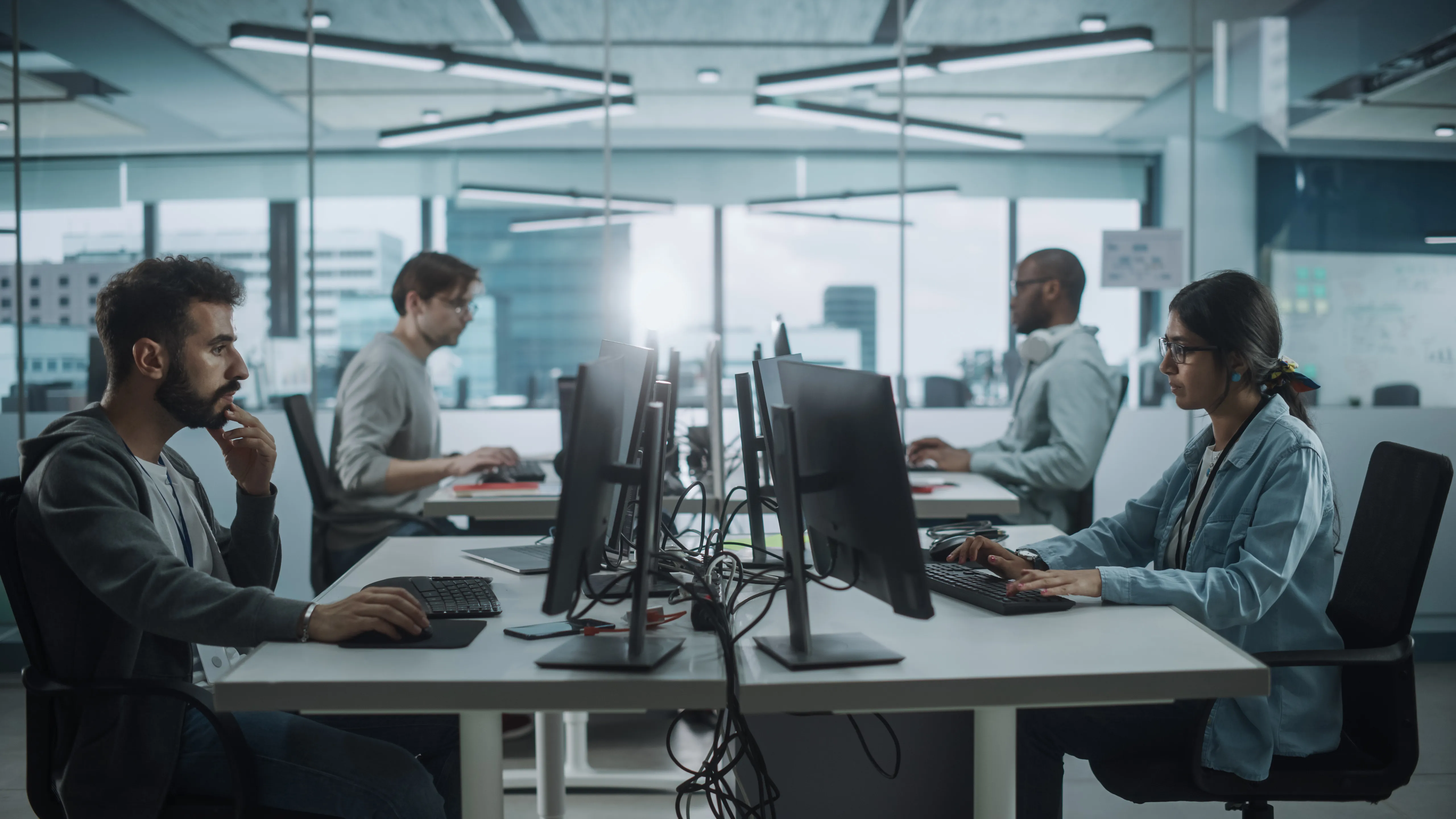 Digital product team collaborating at their workstations