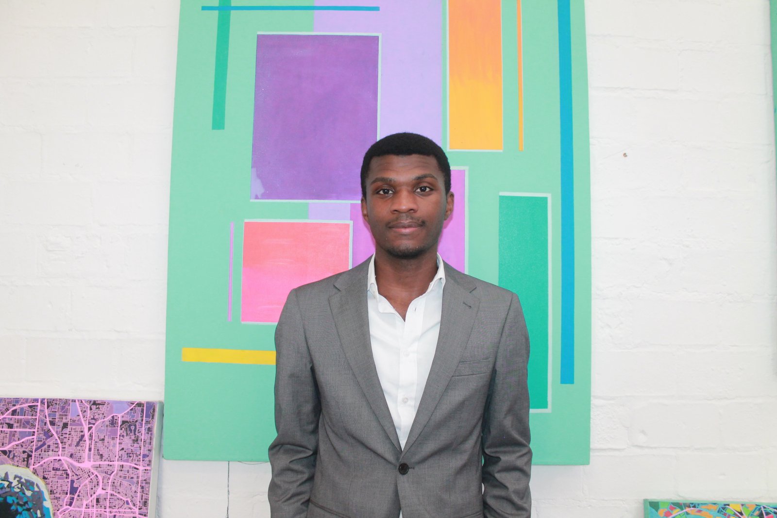 Shinsa Lyonga Lomboto in a grey suit